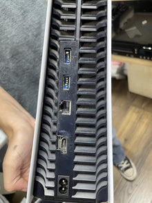Rear port panel of a PlayStation 5, showing the USB, HDMI and power connectors