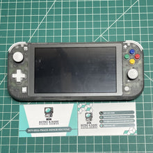 Nintendo Switch Lite on a cutting mat beside two Retro & Rare business cards