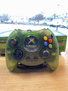Xbox controller in a translucent green shell, on a workbench