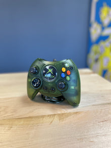 Translucent Xbox controller standing on a table