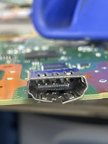 Close up of an HDMI connector on a board with the surrounding components in frame