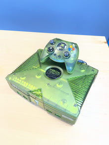 Original Xbox in a translucent green shell, viewed from the front