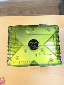 Translucent green Xbox photographed from above on a wooden surface